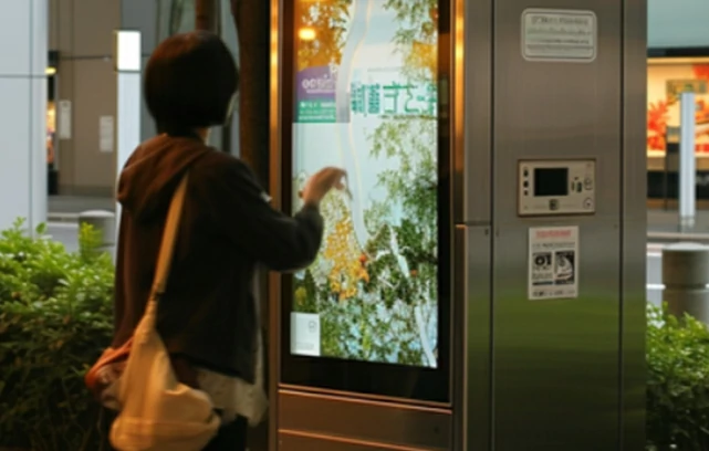 a woman used touch screen in outdoor